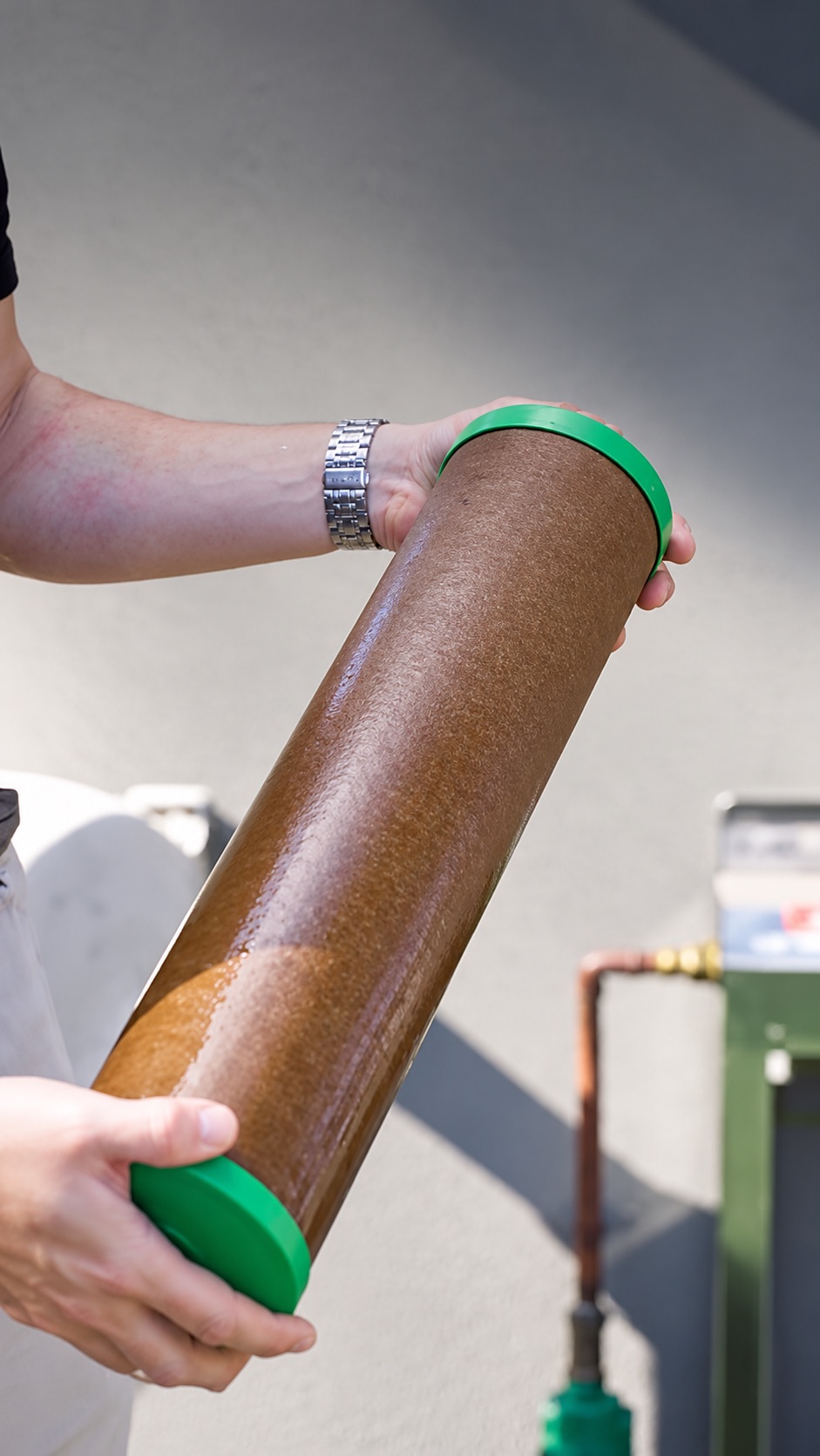 The same filter cartridge after 6 months in a family home, coated brown with sediment
